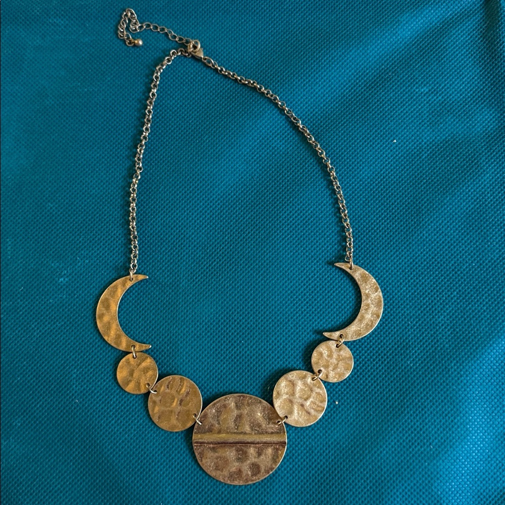 Hammered gold tone necklace.